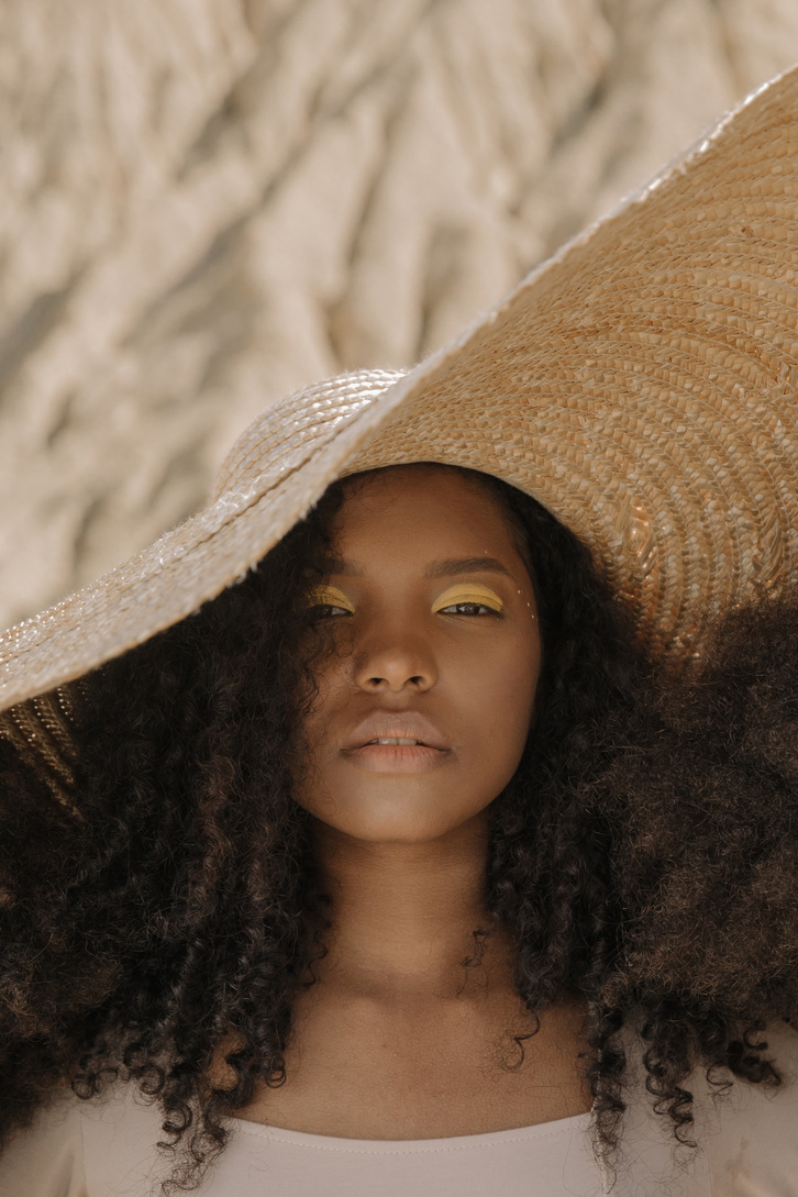 A Woman with Curly Hair Wearing Sunhat